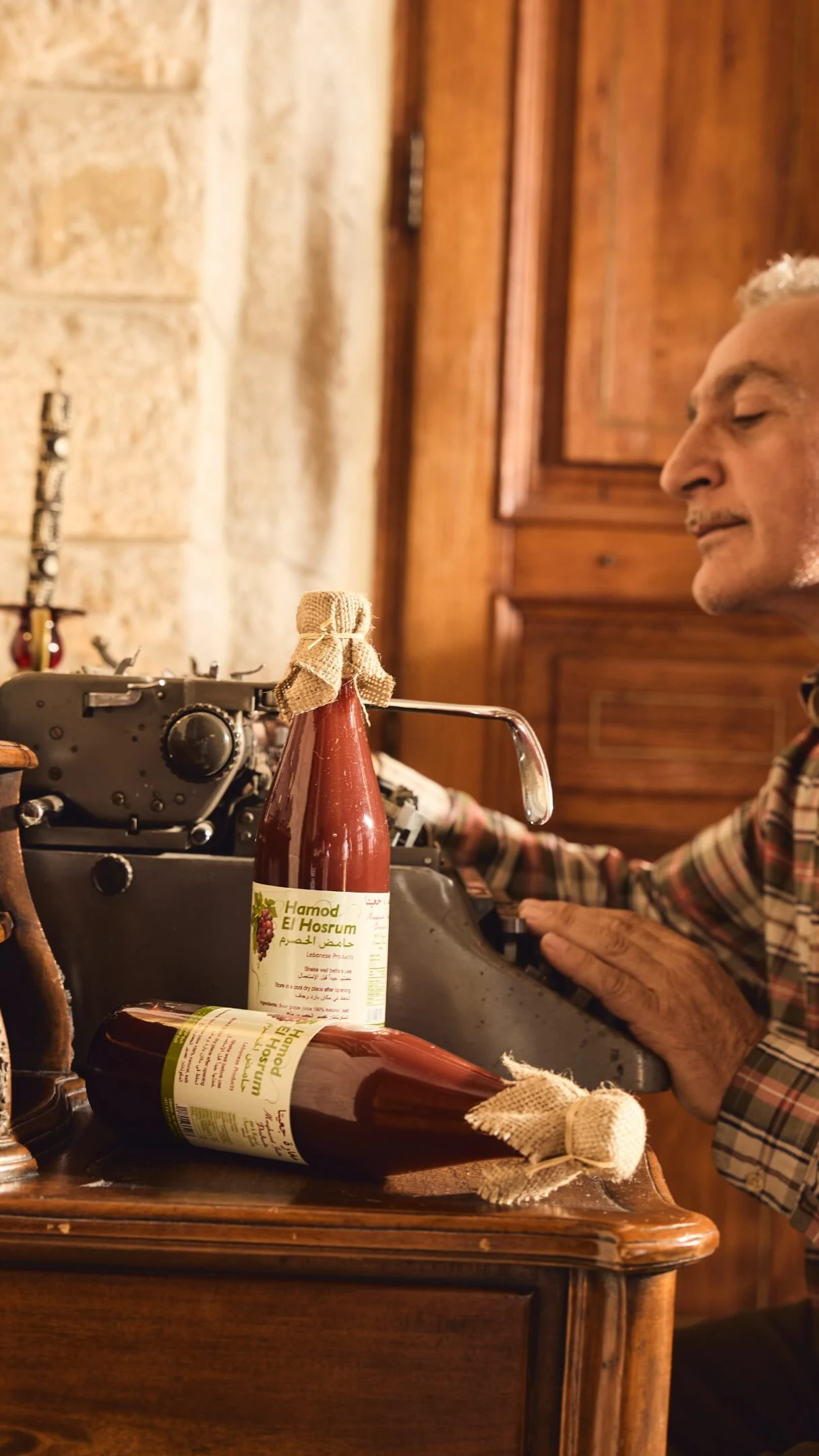 A maker with bottles of Hamod El Hosrum